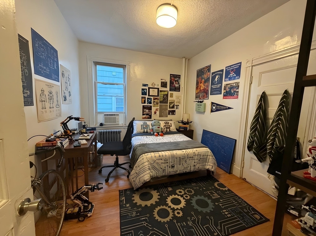34 Cherokee Street, Unit 3 Boston, MA 02120 - Photo 14 of 15 a bed room with a bed and a chair