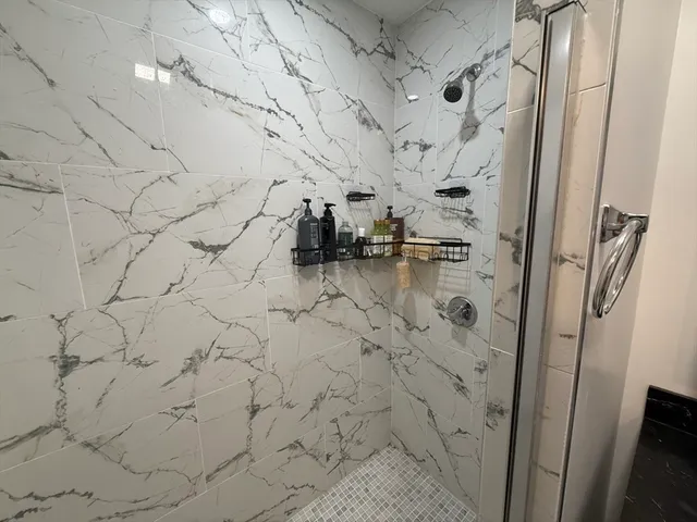 a bathroom with a toilet sink vanity and mirror