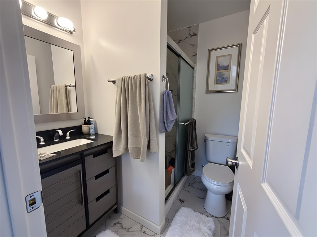 34 Cherokee Street, Unit 3 Boston, MA 02120 - Photo 4 of 15 a bathroom with a toilet sink and a mirror
