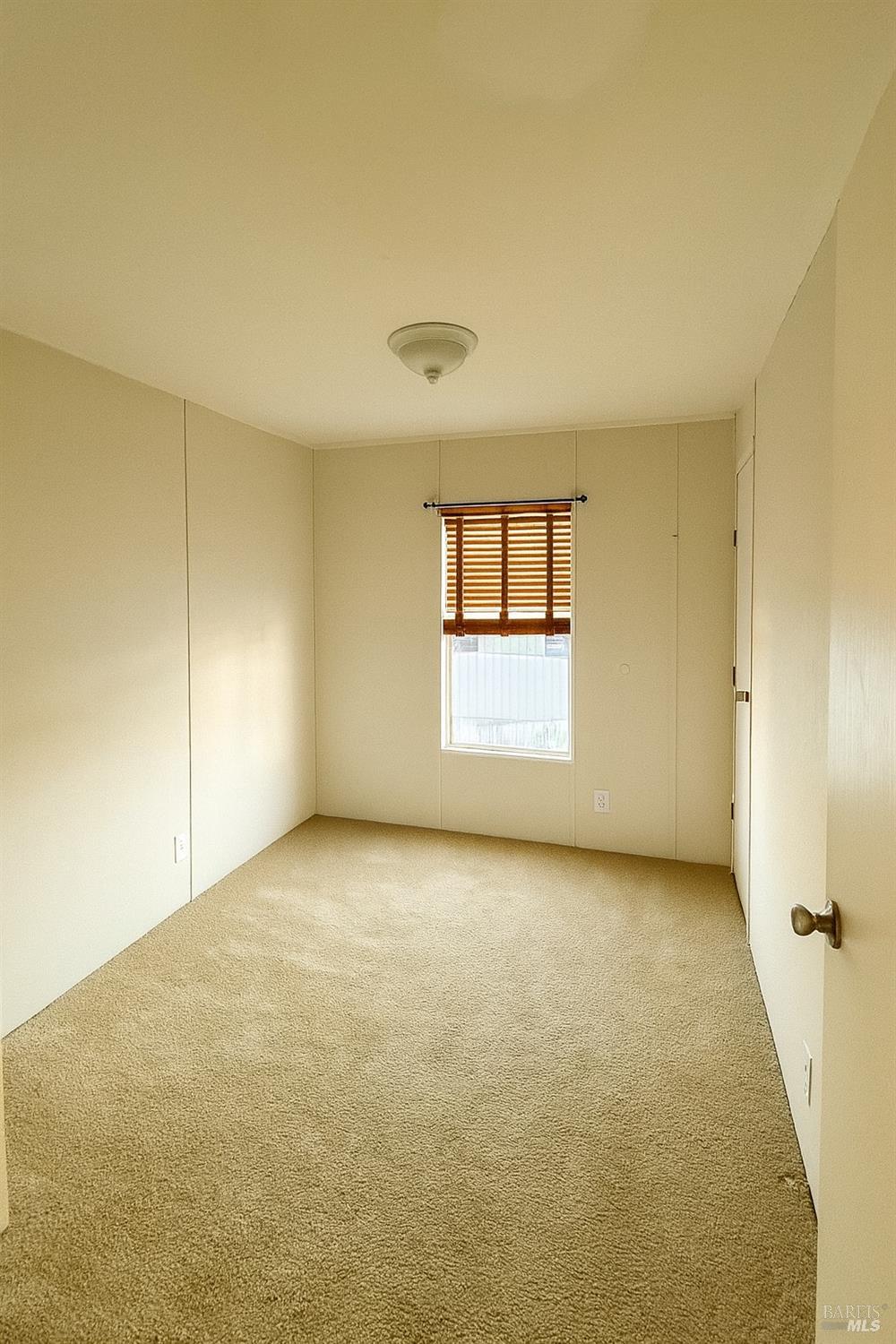 19925 South Main Street, Unit 18 Willits, CA 95490 - Photo 14 of 14 an empty room with a windows and a fireplace