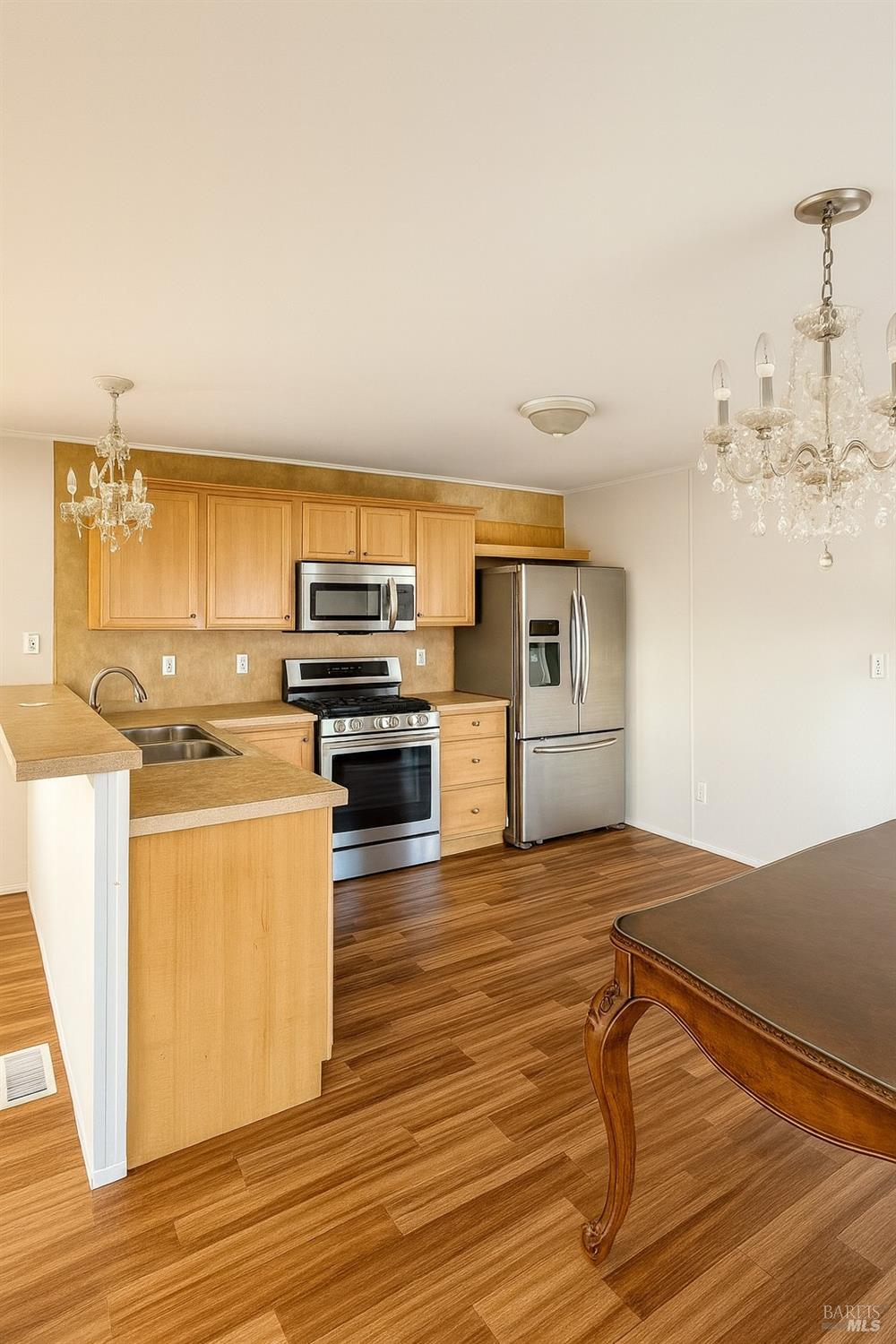 19925 South Main Street, Unit 18 Willits, CA 95490 - Photo 2 of 14 a kitchen with wooden floors and appliances