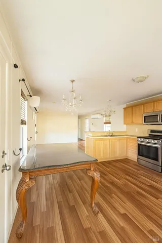 a large white kitchen with kitchen island a stove a sink and a refrigerator