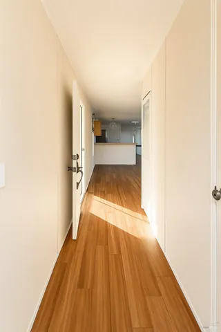a view of a room with wooden floor