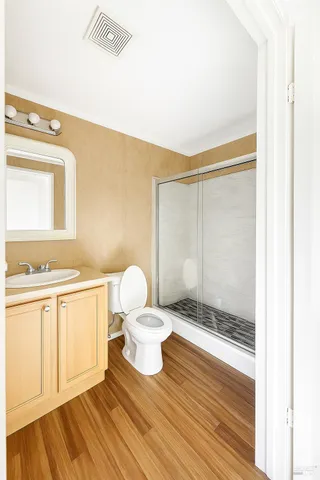 a bathroom with a sink a toilet and shower