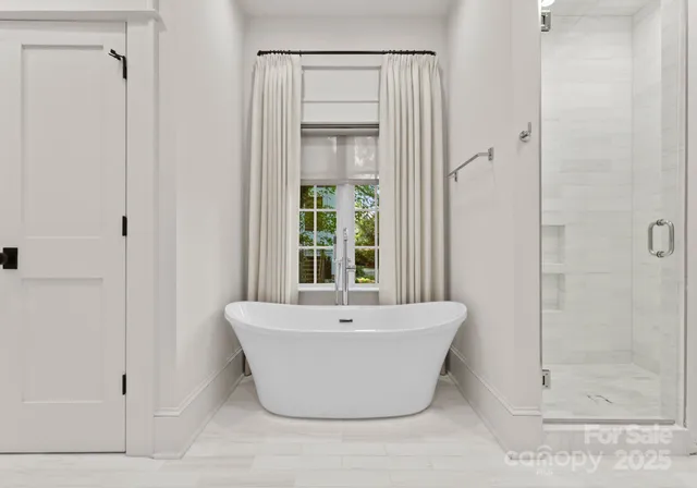 a white bath tub sitting next to a shower
