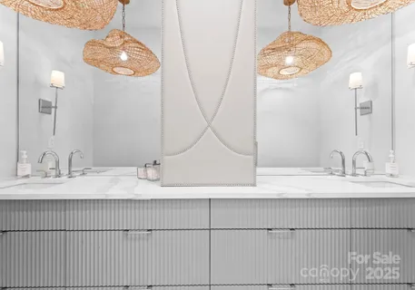 a bathroom with a double vanity sink and a mirror