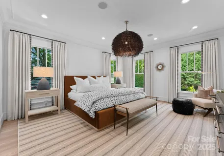 a spacious bedroom with a large bed and a large window