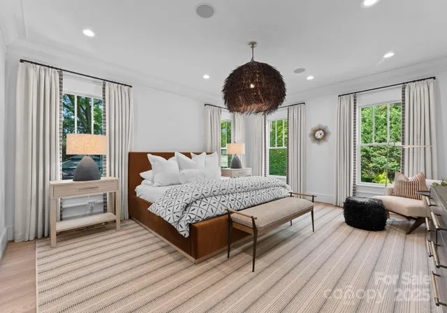 a spacious bedroom with a large bed and a large window