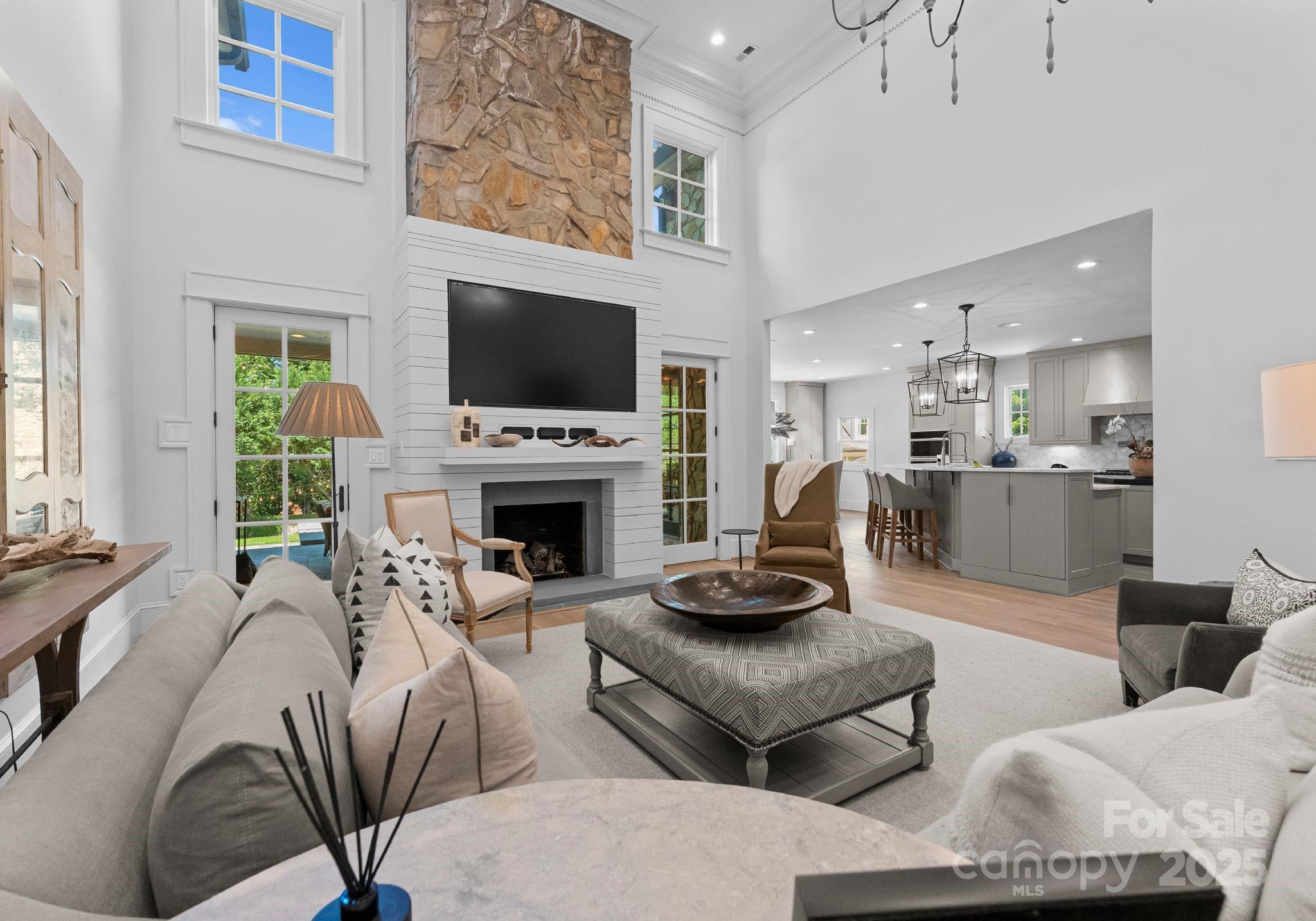 1550 Queens Road West Charlotte, NC 28207 - Photo 14 of 40 a living room with furniture a flat screen tv and a fireplace