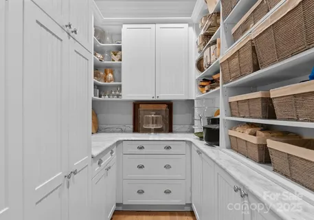 a kitchen with stainless steel appliances cabinets and a window