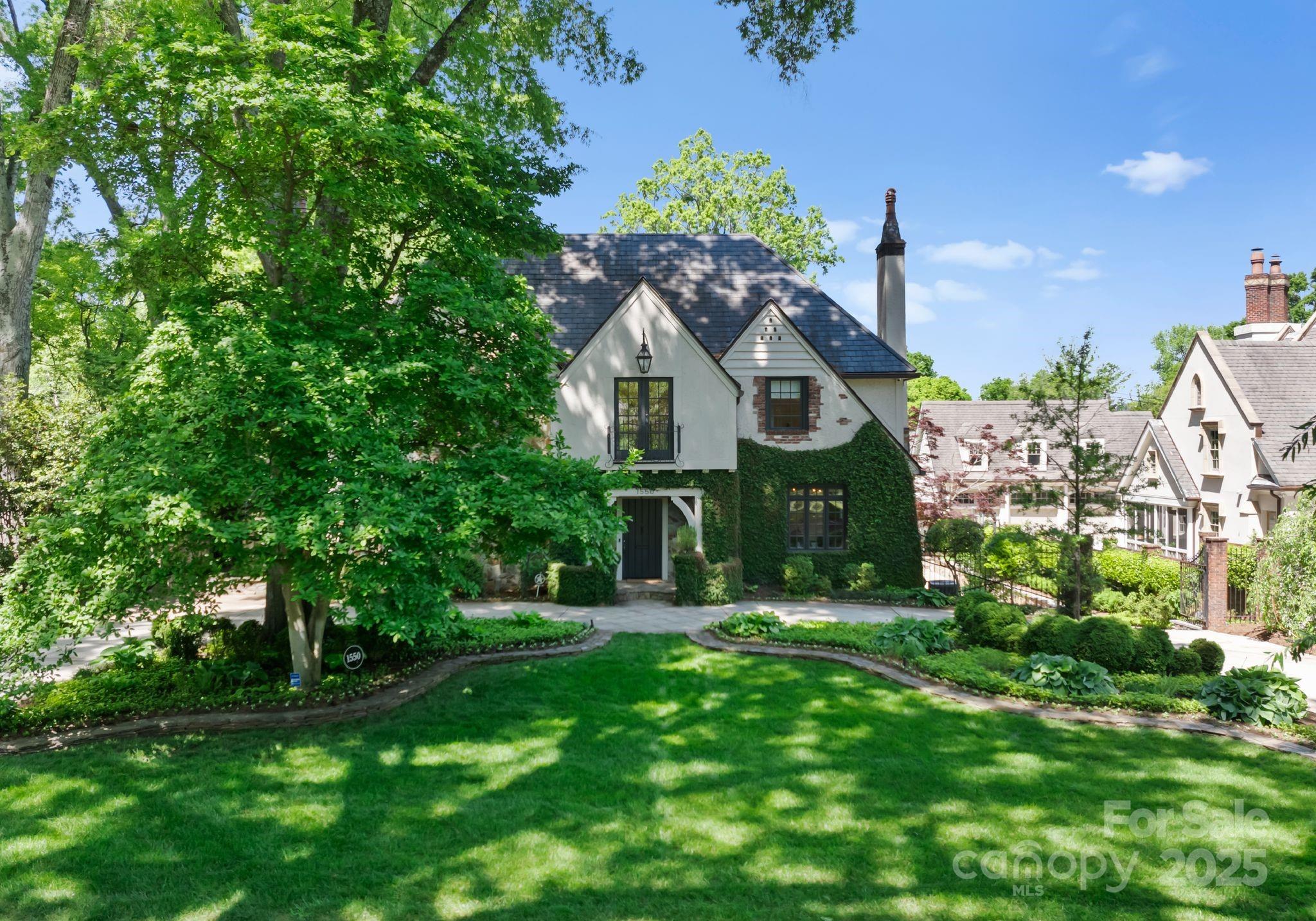 1550 Queens Road West Charlotte, NC 28207 - Photo 2 of 40 a front view of a house with a garden