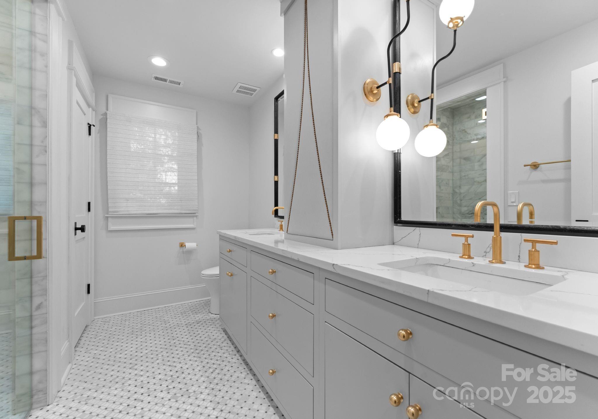 1550 Queens Road West Charlotte, NC 28207 - Photo 26 of 40 a bathroom with a double vanity sink and a mirror