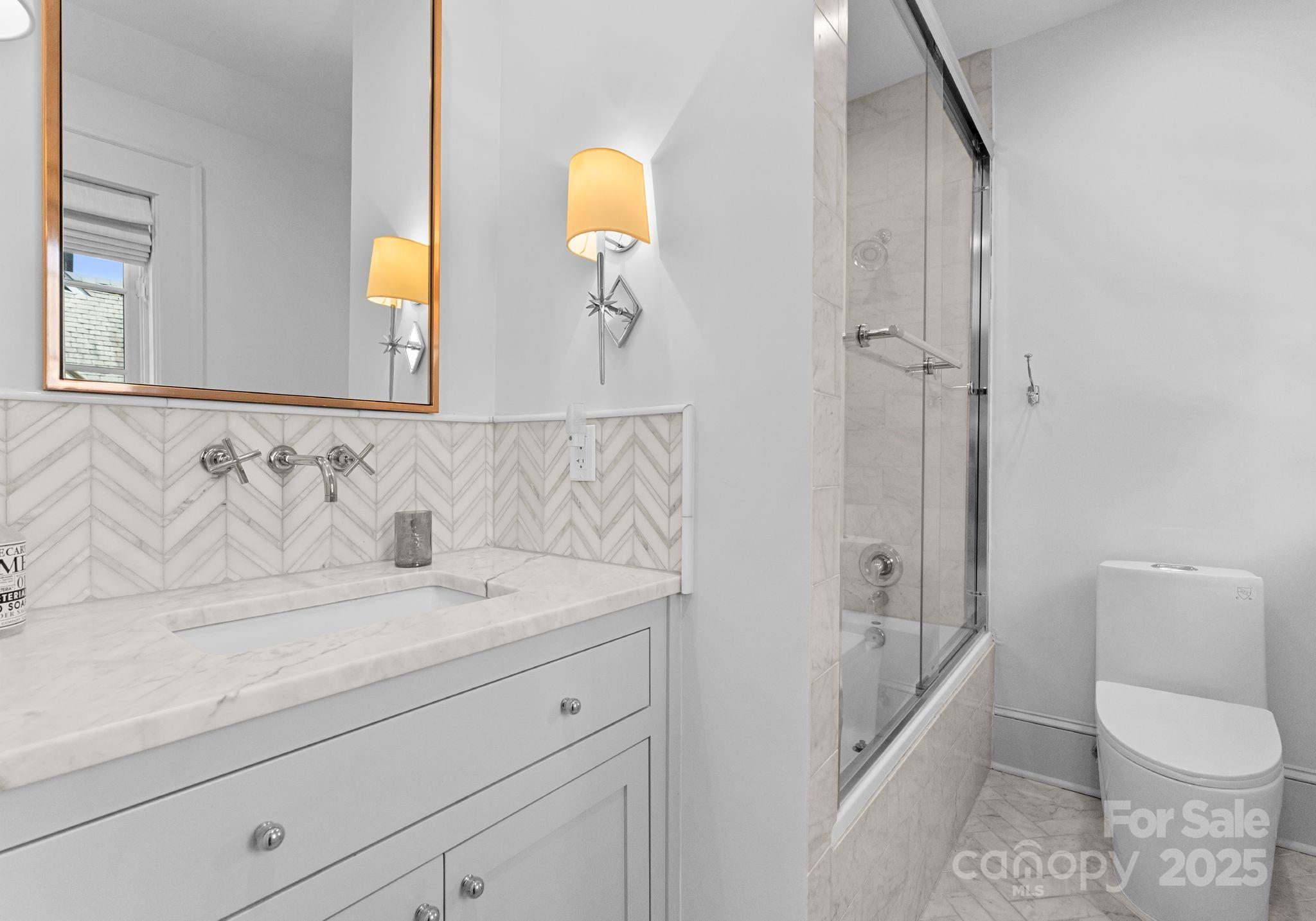 1550 Queens Road West Charlotte, NC 28207 - Photo 30 of 40 a bathroom with a sink a toilet and shower