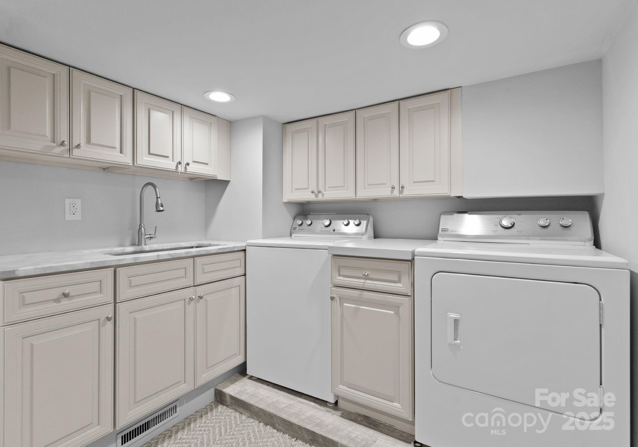 1550 Queens Road West Charlotte, NC 28207 - Photo 34 of 40 a kitchen with white cabinets and sink