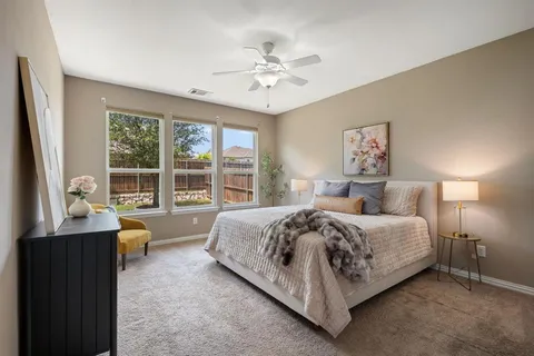 a spacious bedroom with a bed and a large window