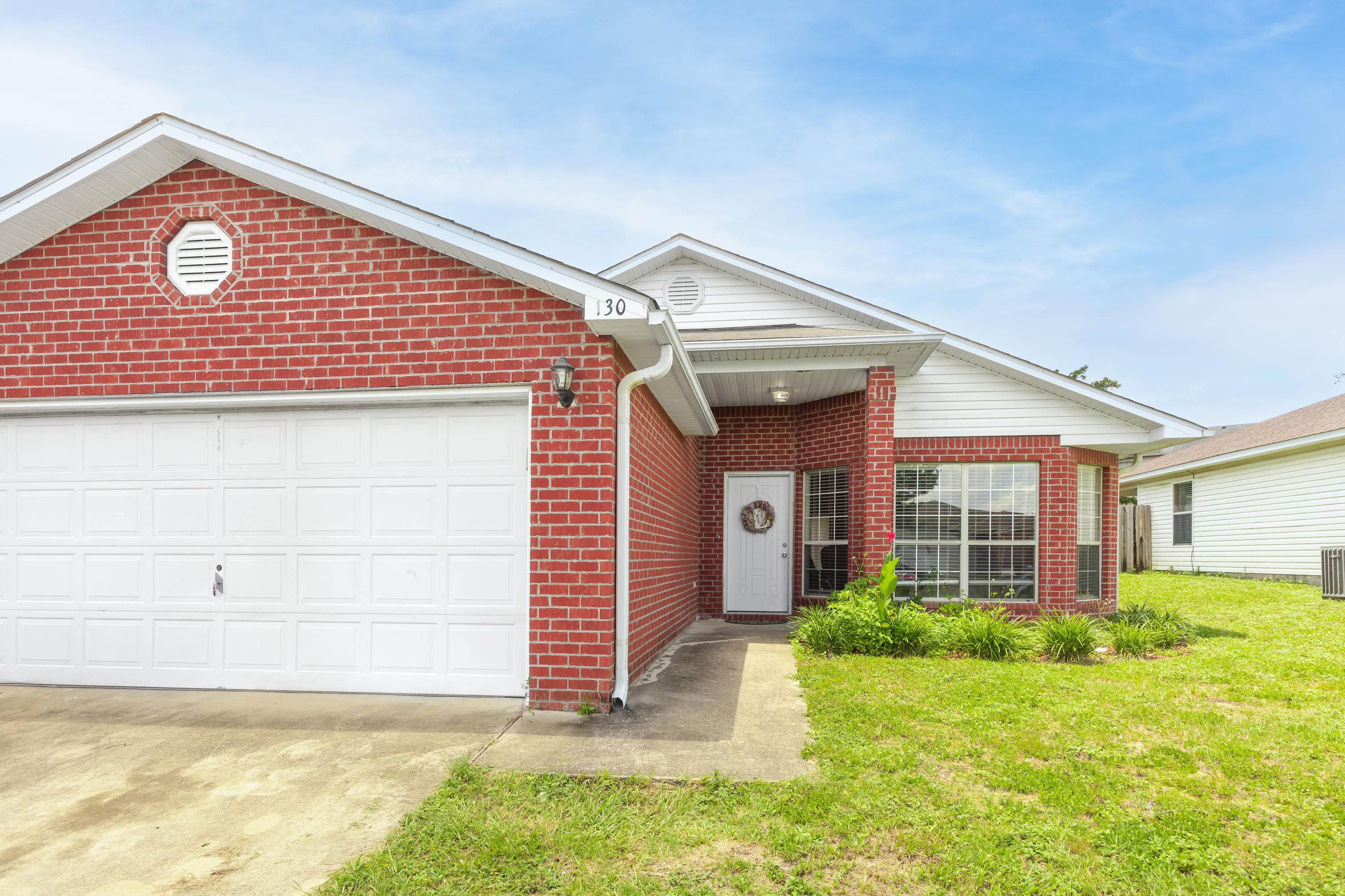 130 Sandstone Trail Crestview, FL 32539 - Photo 2 of 24 a front view of a house with a yard
