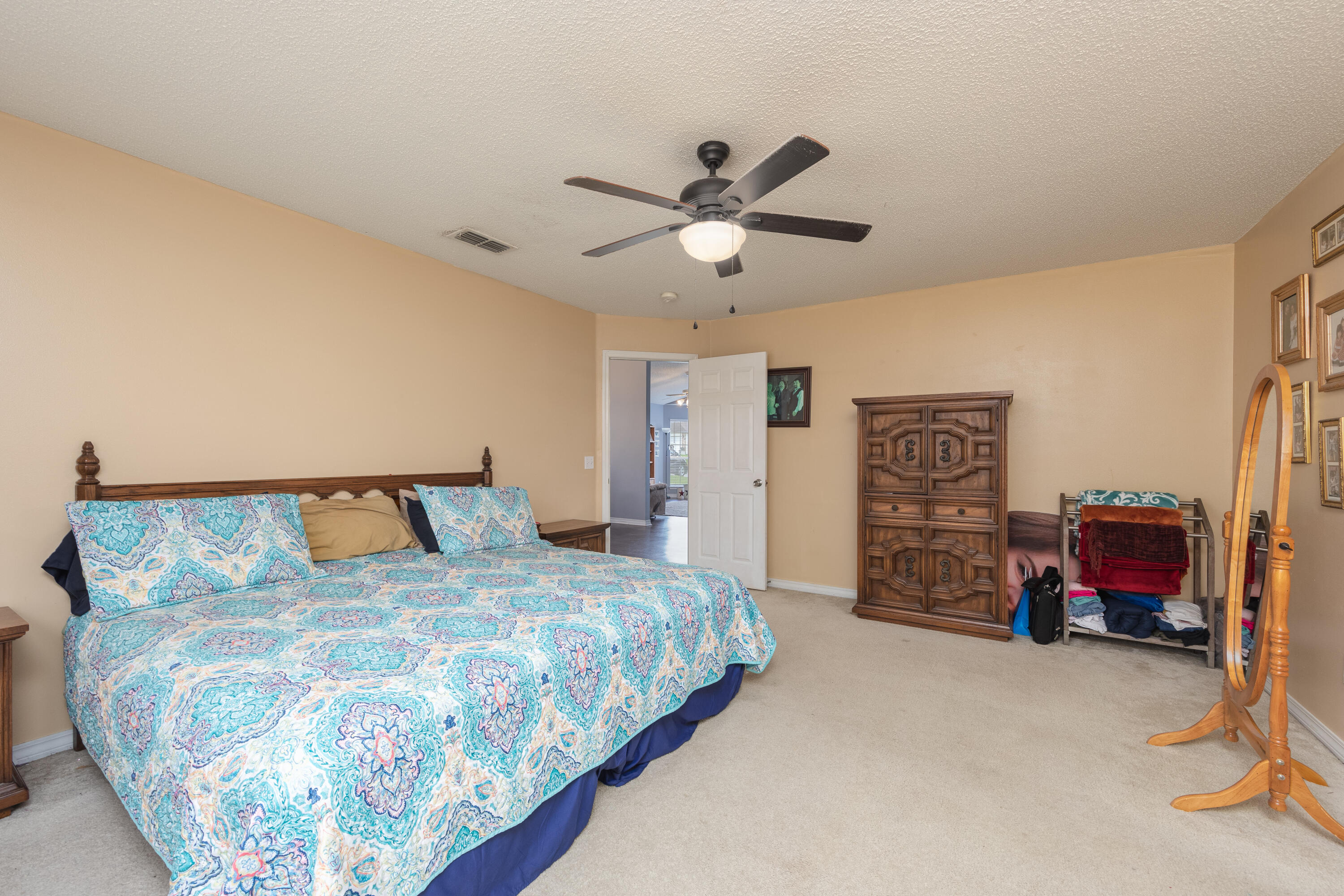 130 Sandstone Trail Crestview, FL 32539 - Photo 18 of 24 a bedroom with bed and a chandelier