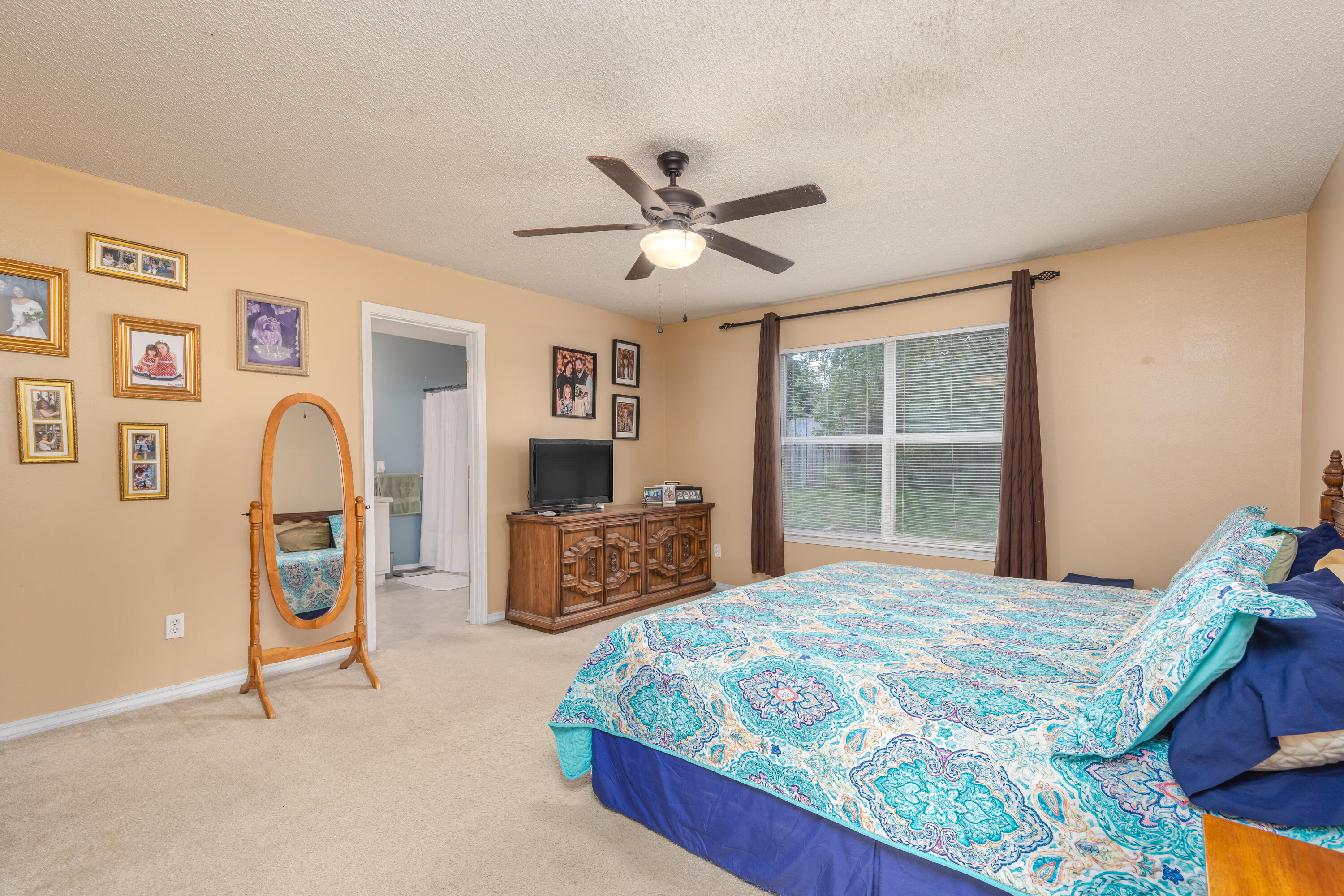 130 Sandstone Trail Crestview, FL 32539 - Photo 19 of 24 a bedroom with a bed dresser and a window