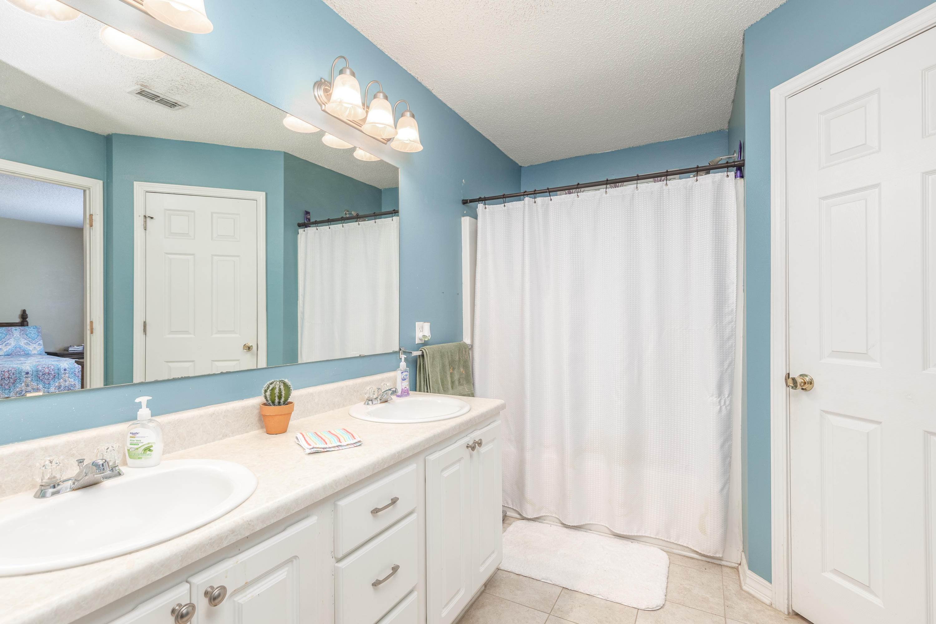 130 Sandstone Trail Crestview, FL 32539 - Photo 20 of 24 a bathroom with a double vanity sink and a mirror