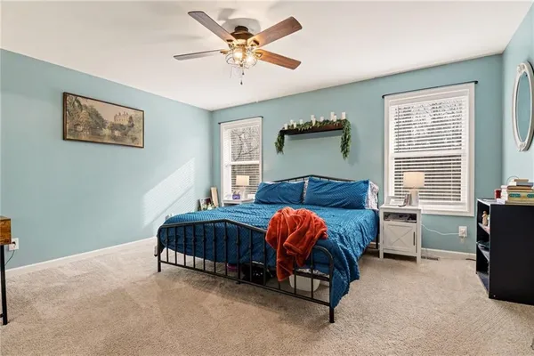 a bed room with a bed and a chair