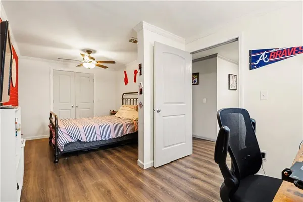 a bedroom with a bed and a chair