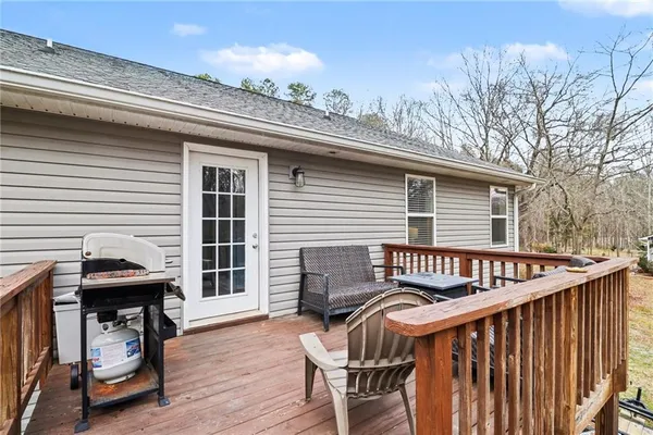 a view of a roof deck with wooden fence and a barbeque