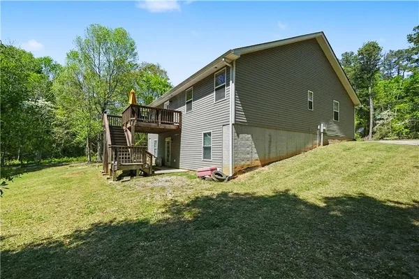 a backyard of a house with table and chairs