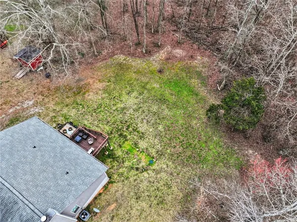 an aerial view of a houses with a yard