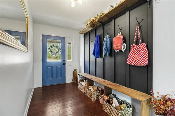 a view of hallway with wooden floor and stairs