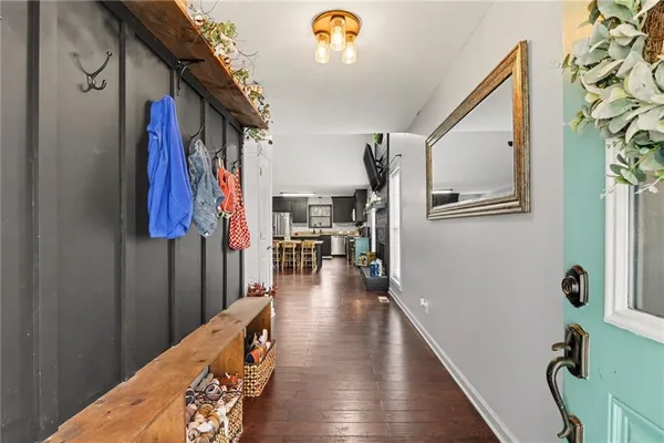 a hallway with furniture and a wooden floor
