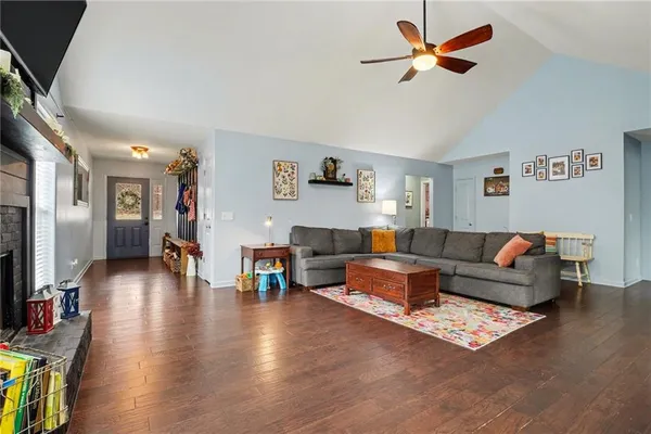 a living room with furniture and a wooden floor