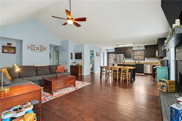 a living room with furniture kitchen view and a dining table