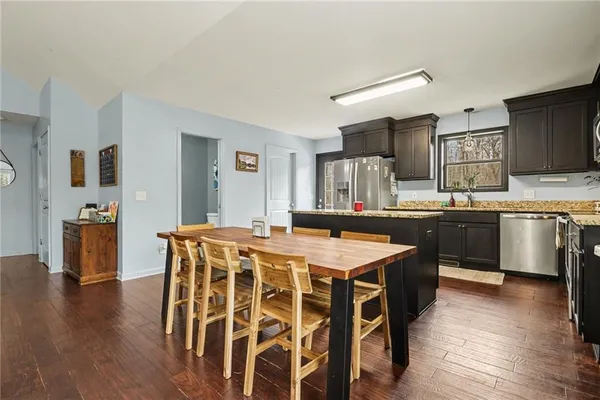 a large kitchen with a table and chairs
