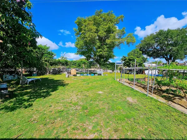 a view of yard with swimming pool and green space