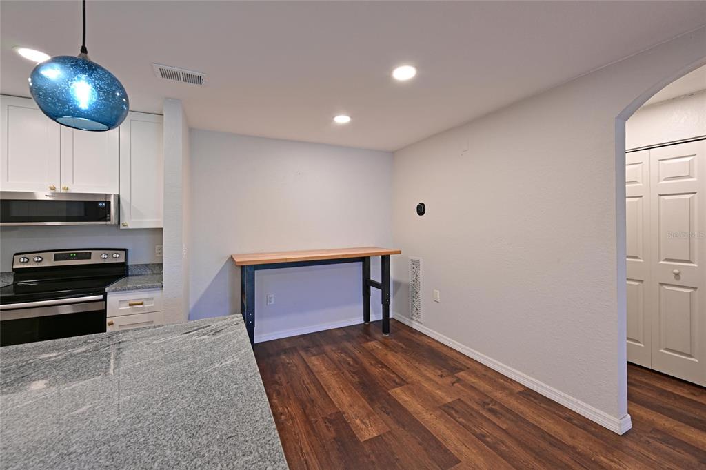 8809 Manor Loop, Unit 106 Lakewood Ranch, FL 34202 - Photo 17 of 40 a kitchen with wooden floor and a sink