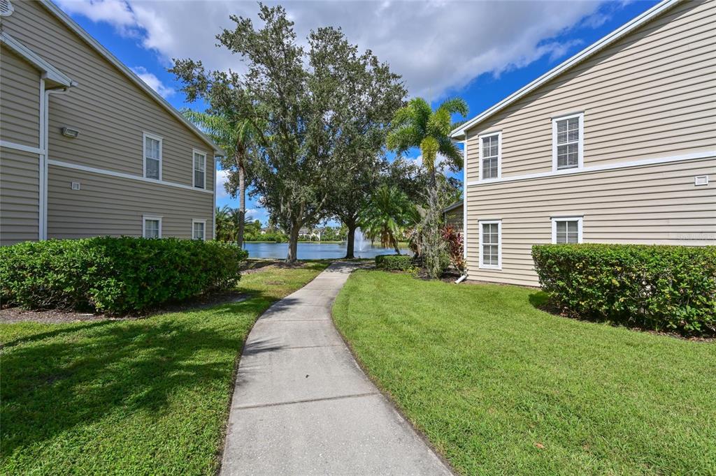 8809 Manor Loop, Unit 106 Lakewood Ranch, FL 34202 - Photo 20 of 40 a front view of a house with a yard