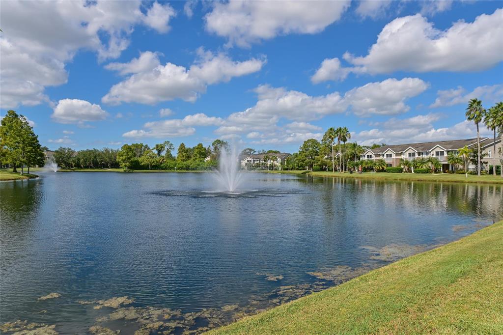 8809 Manor Loop, Unit 106 Lakewood Ranch, FL 34202 - Photo 21 of 40 a view of a lake with houses in the back