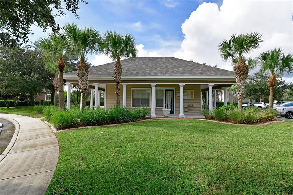 8809 Manor Loop, Unit 106 Lakewood Ranch, FL 34202 - Photo 27 of 40 a front view of a house with a yard and garage