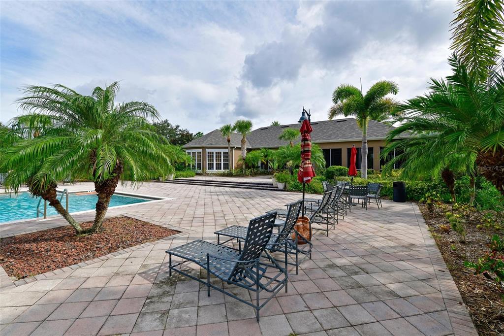 8809 Manor Loop, Unit 106 Lakewood Ranch, FL 34202 - Photo 31 of 40 a swimming pool with outdoor seating