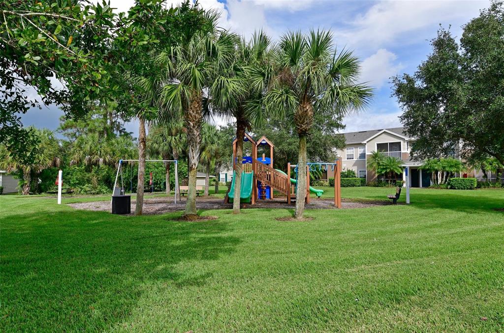 8809 Manor Loop, Unit 106 Lakewood Ranch, FL 34202 - Photo 39 of 40 a view of a park with large trees