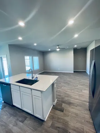 a kitchen with stainless steel appliances kitchen island a sink and refrigerator