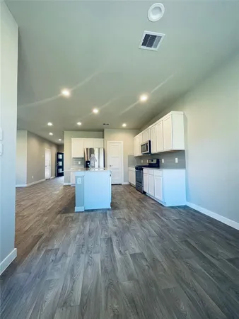 a view of kitchen with cabinets and wooden floor