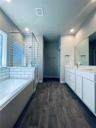 a bathroom with a double vanity sink and mirror