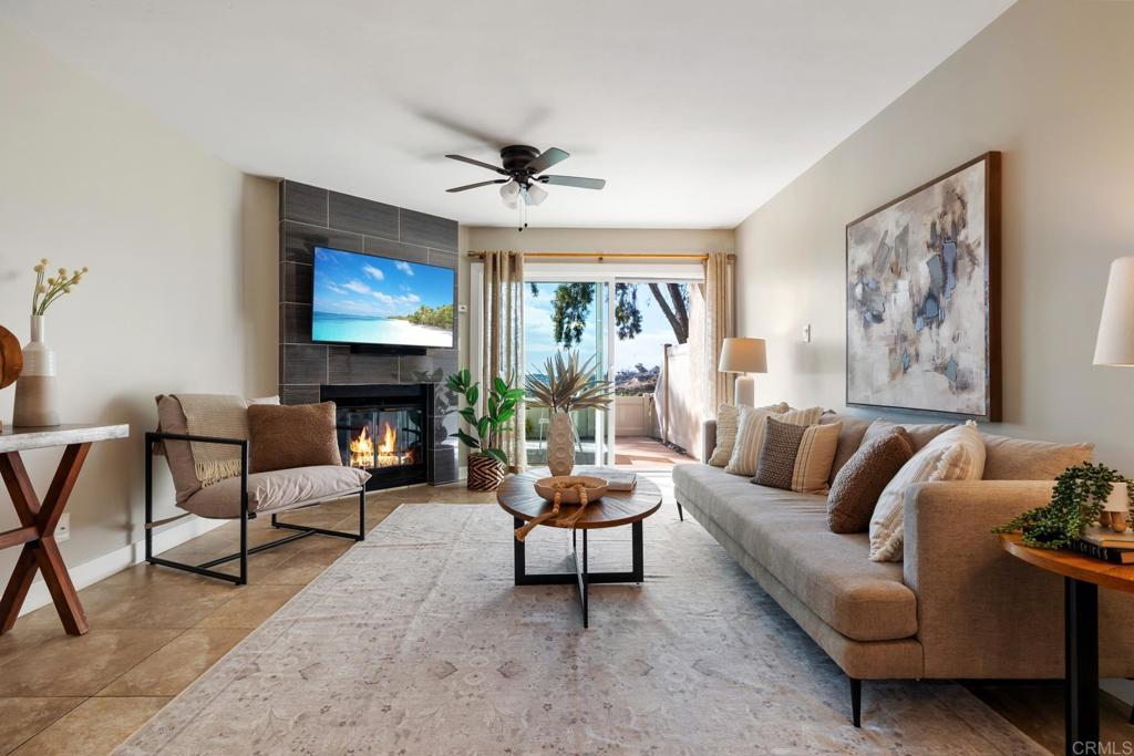 a living room with furniture a fireplace and a flat screen tv
