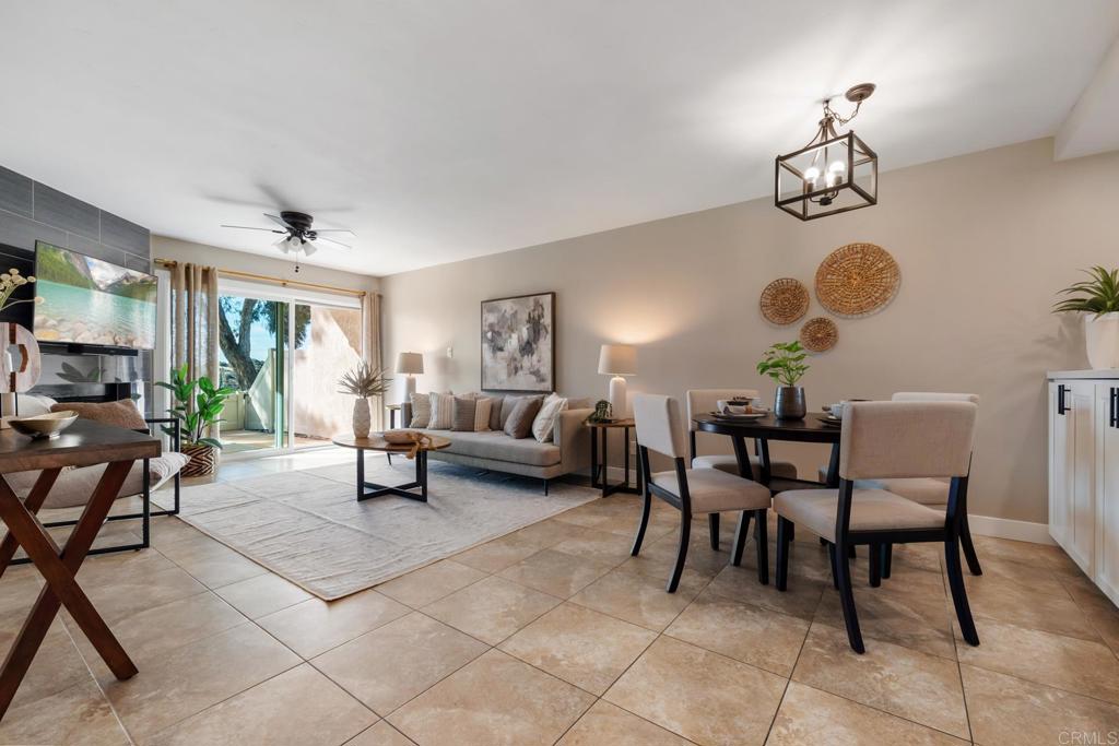 132 South Jayton Lane Encinitas, CA 92024 - Photo 11 of 37 a living room with couches a fireplace and a dining table with wooden floor