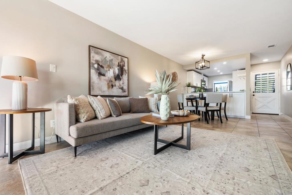 132 South Jayton Lane Encinitas, CA 92024 - Photo 12 of 37 a living room with furniture and a dining table with kitchen view