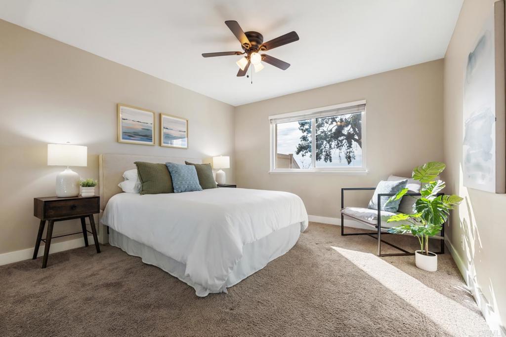 132 South Jayton Lane Encinitas, CA 92024 - Photo 18 of 37 a bedroom with a bed and a chandelier