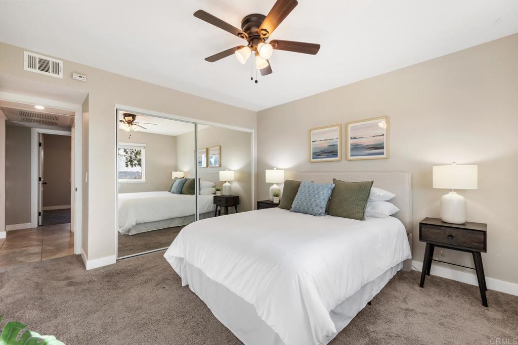 132 South Jayton Lane Encinitas, CA 92024 - Photo 19 of 37 a bedroom with bed and a chandelier