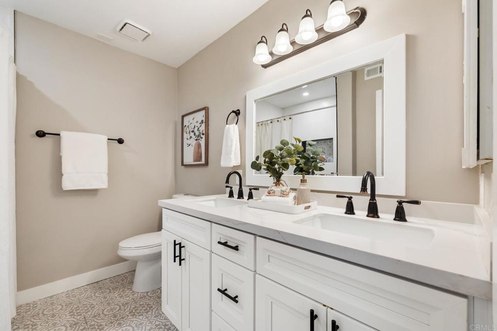 132 South Jayton Lane Encinitas, CA 92024 - Photo 20 of 37 a bathroom with a sink vanity and a toilet