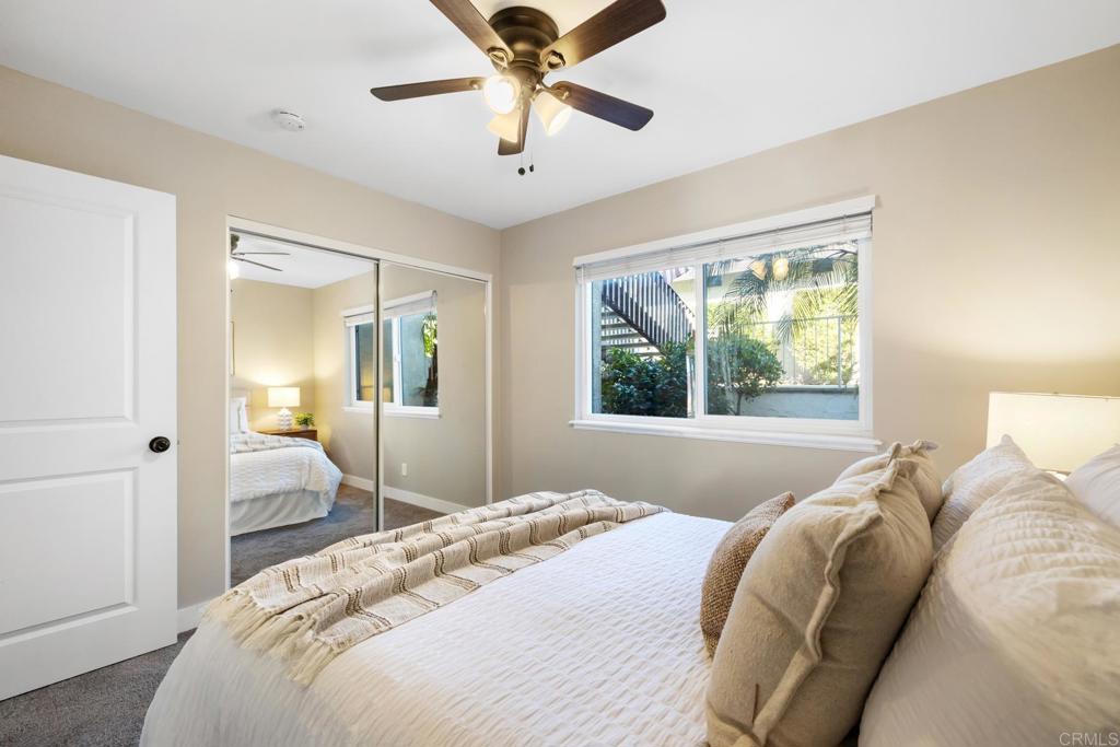 132 South Jayton Lane Encinitas, CA 92024 - Photo 23 of 37 a bedroom with a bed and a chandelier